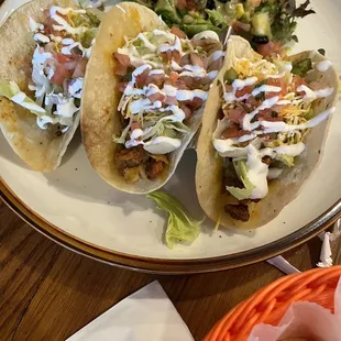 a plate of tacos and a salad