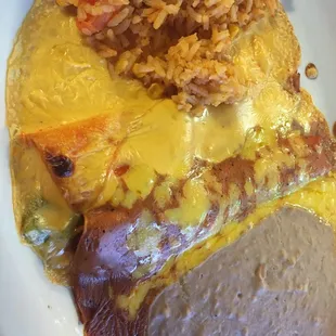 Cheese enchiladas, one with queso on top, one with gravy.