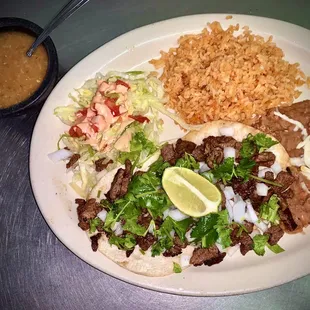 Asada taco plate served with rice and beans.
