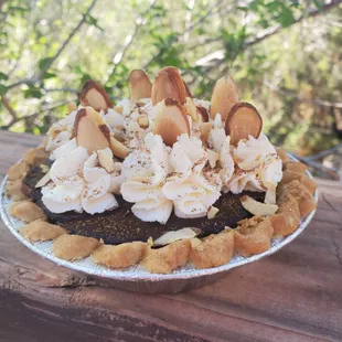 a chocolate pie topped with whipped cream and toasted almonds
