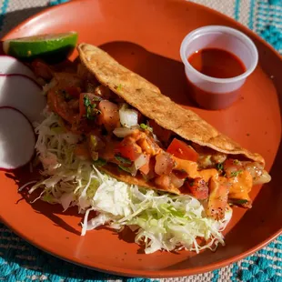 Crispy hardshell pescadilla fish taco with pico de gallo, chipotle mayo, and salsa Valentina for a flavorful, spicy kick.