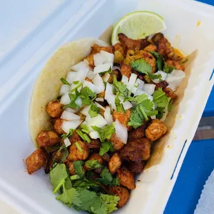 Puerco taco topped with pineapple salsa