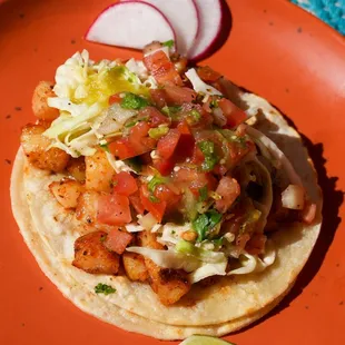 Our most popular taco: Fish taco with slaw, pico de gallo, and salsa verde for a fresh and flavorful bite.