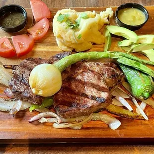 Steak New Mexico: 12-ounce prime ribeye with grilled onions and peppers, mashed potatoes, and two sauces