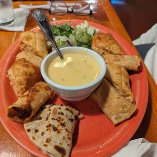 Sampler platter with tasty chicken chimis and taquitos