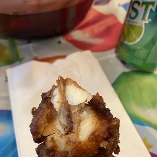 a hand holding a fried food item