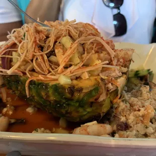 a pineapple filled with rice and vegetables