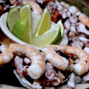 a plate of seafood with a lime wedge