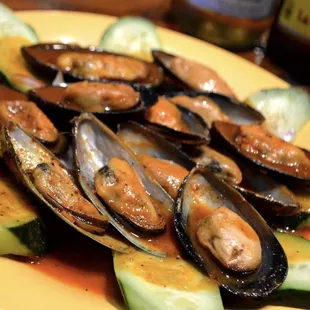 a plate of mussels and cucumbers