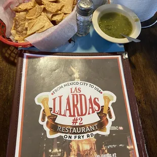  a plate of tortillas and a bowl of guacamole