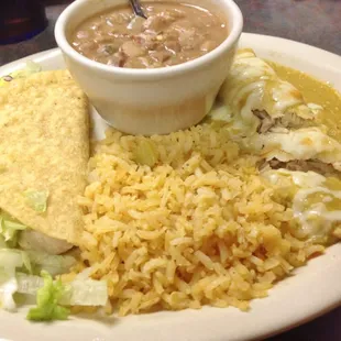 Pollitos Plate. Chicken enchilada, chicken crispy taco