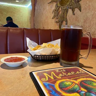 a mexican restaurant with a menu and a glass of beer