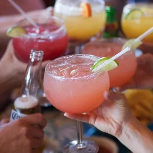 a group of people toasting with drinks