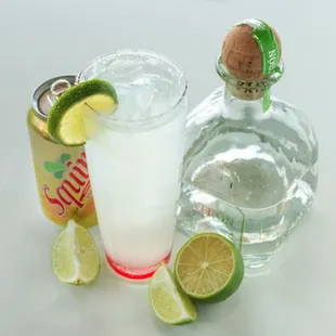 a shot of a drink and a can