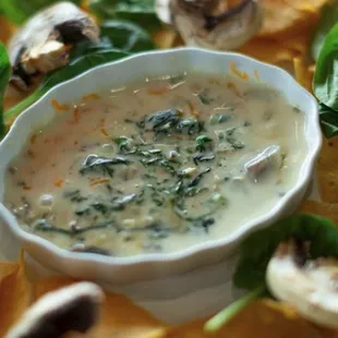 a bowl of cheese and spinach dip
