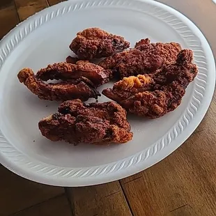 fried chicken wings on a paper plate