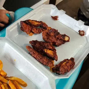 a tray of fries and a tray of bacon