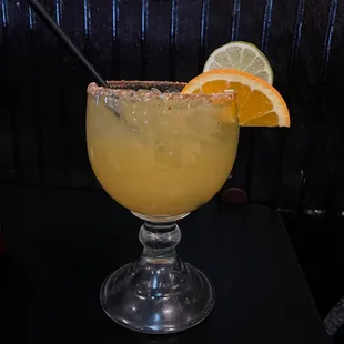 a margarita with a slice of orange on the rim