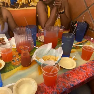 two women sitting at a table with drinks