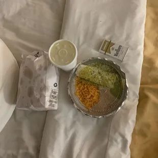 Large queso, chips there is one more bag, and burrito with rice and beans, pack of cigs for reference