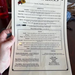 a person holding a menu