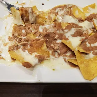 a plate of nachos with sauce