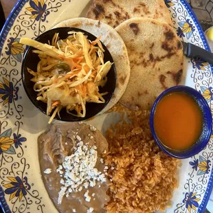 Pupusas, cabbage, tomato sauce, rice, beans.