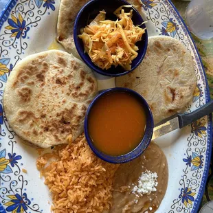 Pupusas, cabbage, tomato sauce, rice and beans.