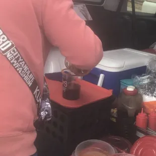 a woman preparing drinks in a car