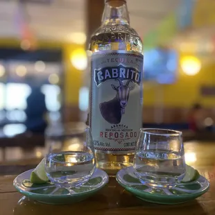 a bottle of cabrito and two shot glasses