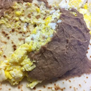 a burrito with eggs and beans