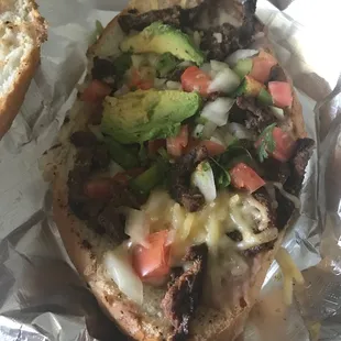 a sandwich with meat and vegetables