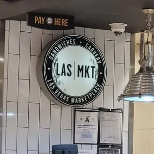 a sign above a counter in a restaurant