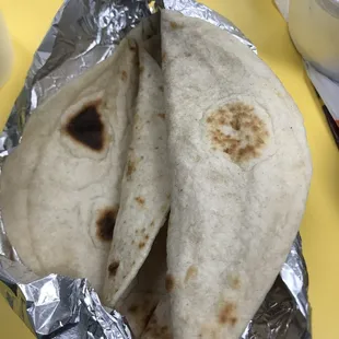 two tortillas wrapped in aluminum foil