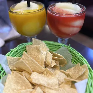 Mango margarita and a strawberry margarita and chips