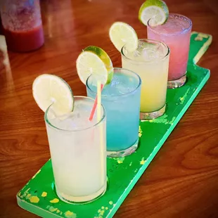 a row of drinks on a tray