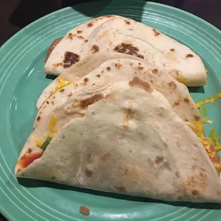 two tortillas on a green plate