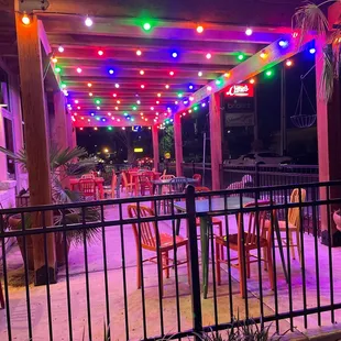 a patio with colorful lights