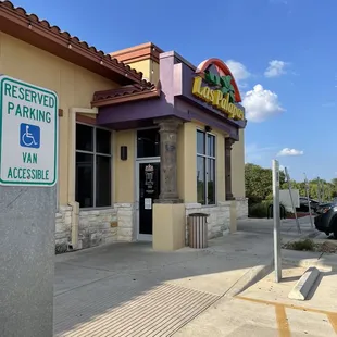 a parking sign in front of a restaurant