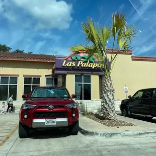 a car parked in front of a restaurant