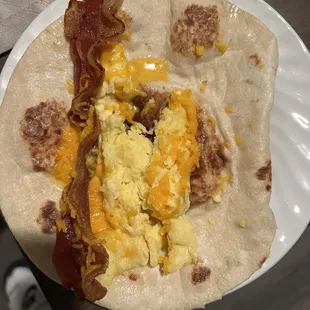 Trash bacon egg and cheese taco. Barely any egg, picture is AFTER I had to microwave it because it was ice cold wrapped in foil