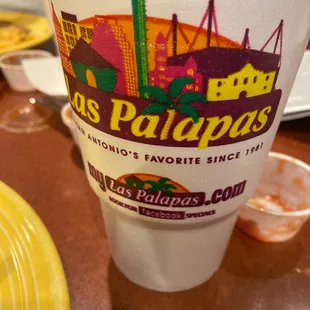 a hot dog in a paper cup