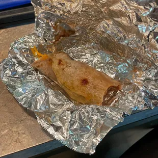 Soaking in grease Bean and Cheese taco, didn't get bacon that I paid for by the way.