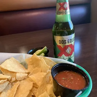 a plate of chips and a bottle of beer