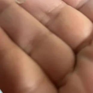 a hand holding a small piece of plastic