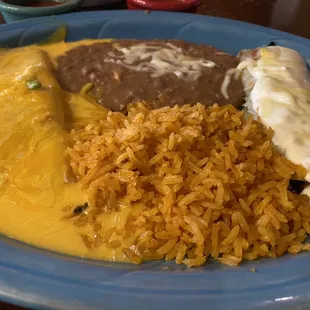 Cheese and spinach enchiladas with rice and beans