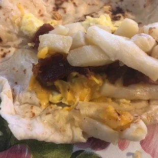 Insides of potato egg bacon cheese. Me likes. Could be more bacon, but when can't you have more bacon.