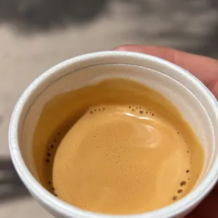 a hand holding a cup of coffee