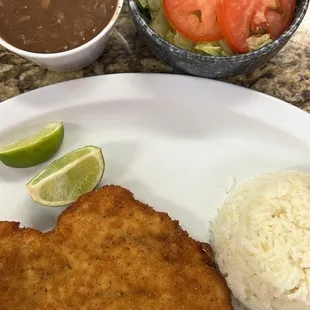 Our Pollo Empanizado served here with White Rice, Red Beans, and a side of Salad