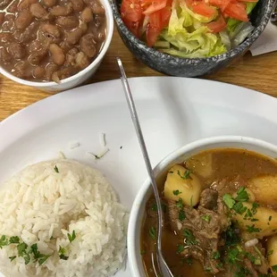 Our Carne Con Papas. Stewed Beef with Potatoes served here with White Rice, Red Beans, and a side of Salad.